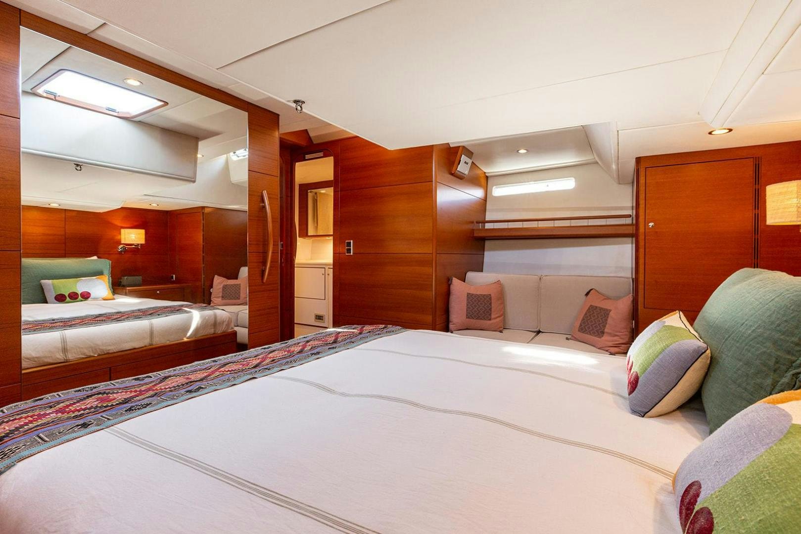 a room with a bed and a couch aboard FRIDA Yacht for Sale