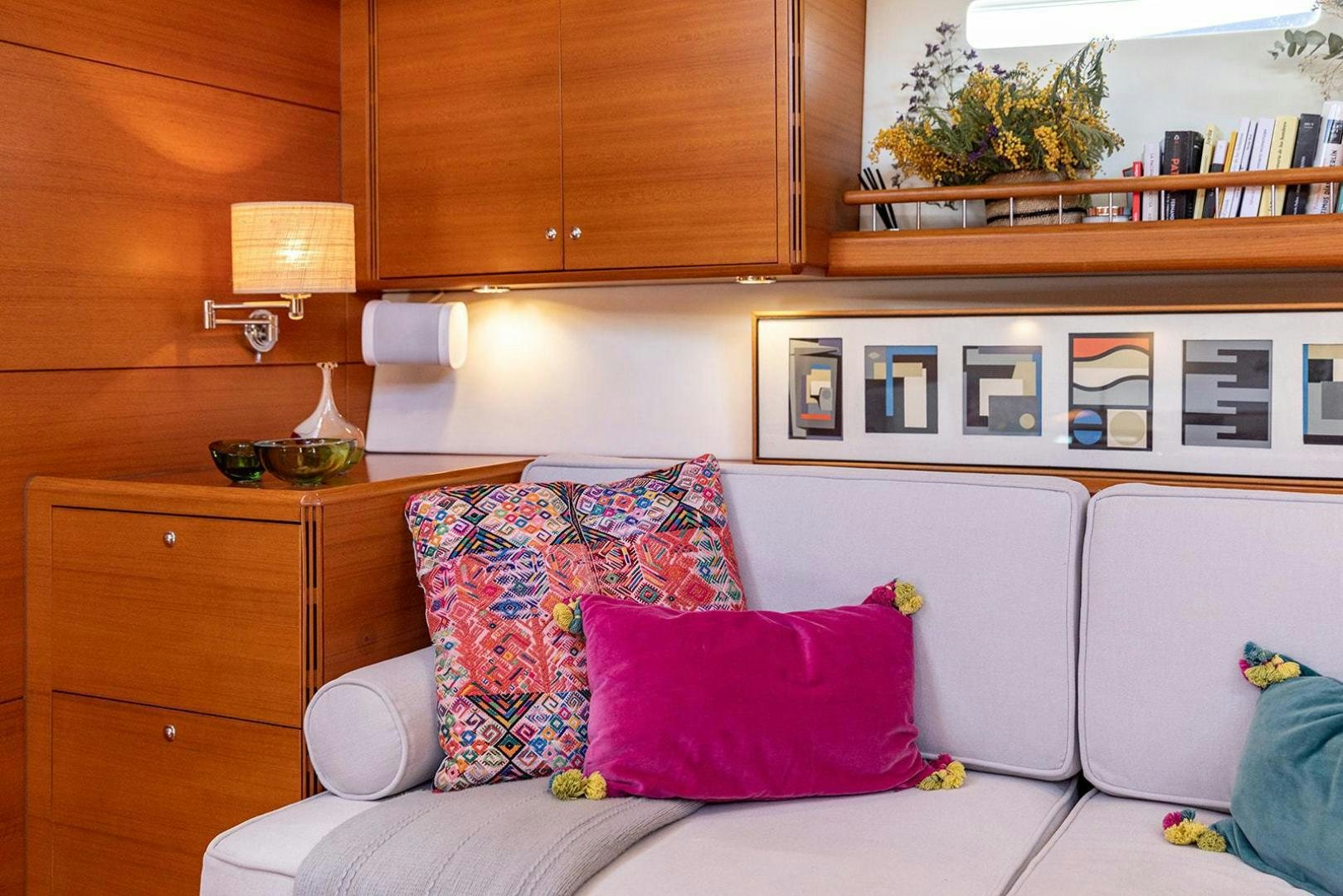 a white couch with colorful pillows aboard FRIDA Yacht for Sale