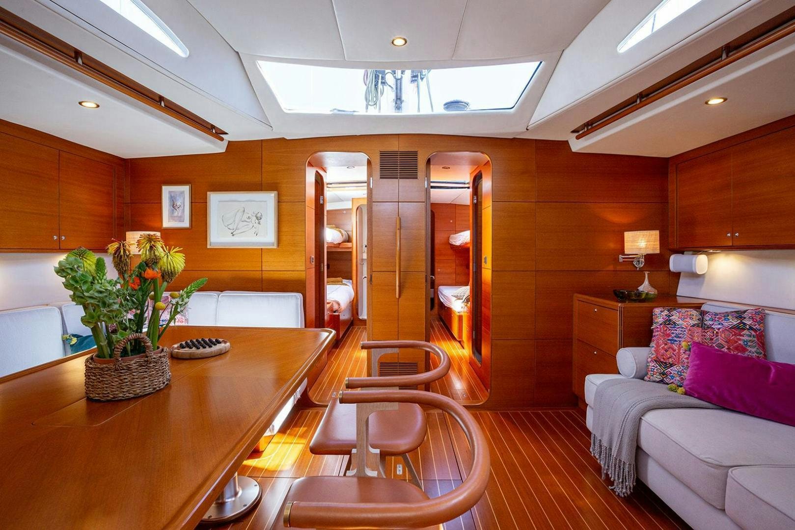 a room with a table and couches aboard FRIDA Yacht for Sale
