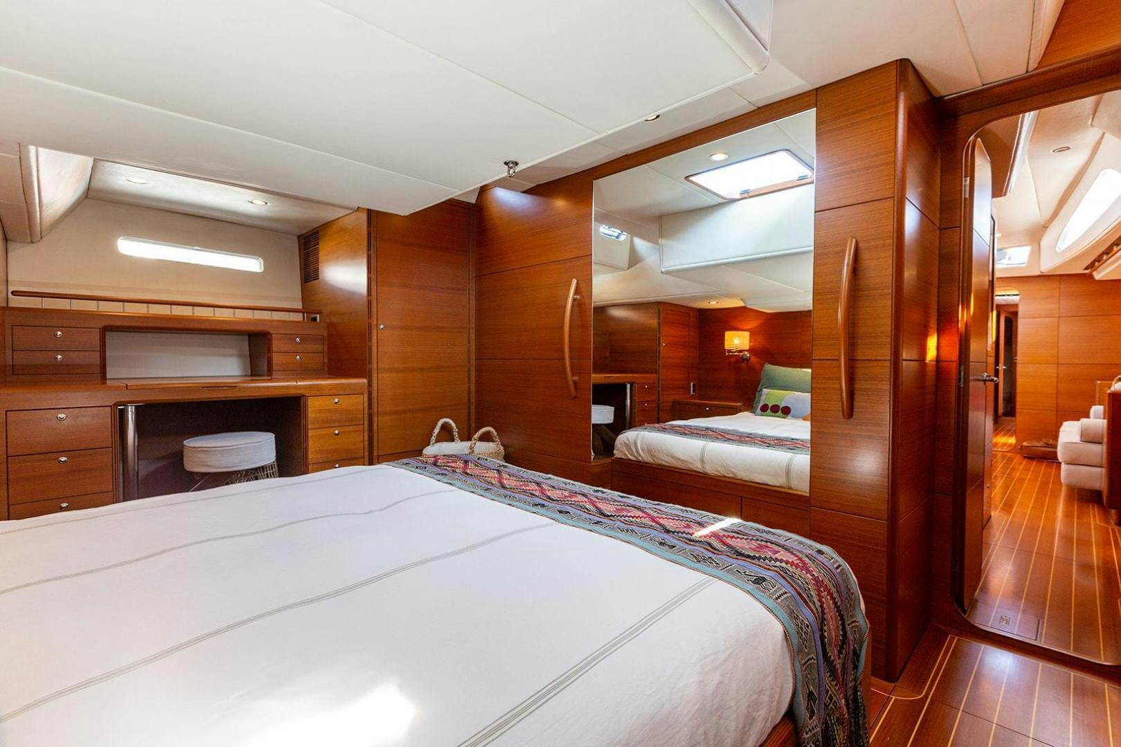 a room with a bed and a wood door aboard FRIDA Yacht for Sale