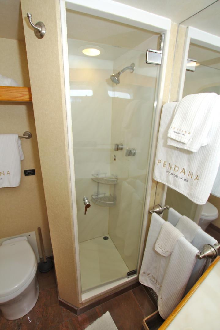 a bathroom with a glass shower door aboard PENDANA Yacht for Sale