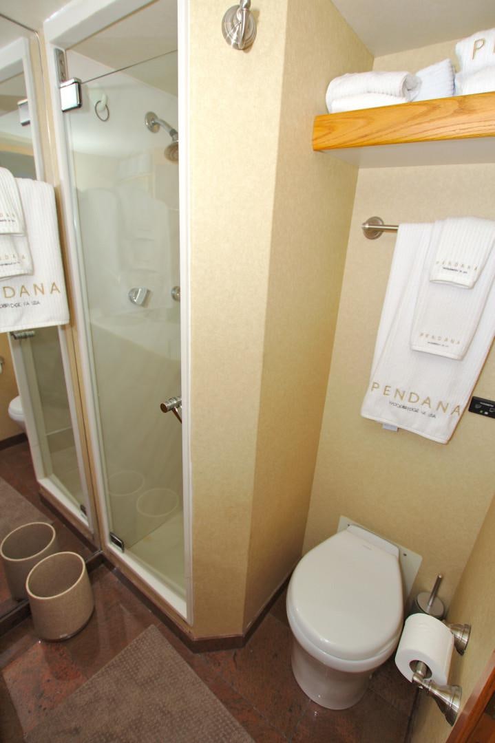 a bathroom with a toilet and a shower aboard PENDANA Yacht for Sale