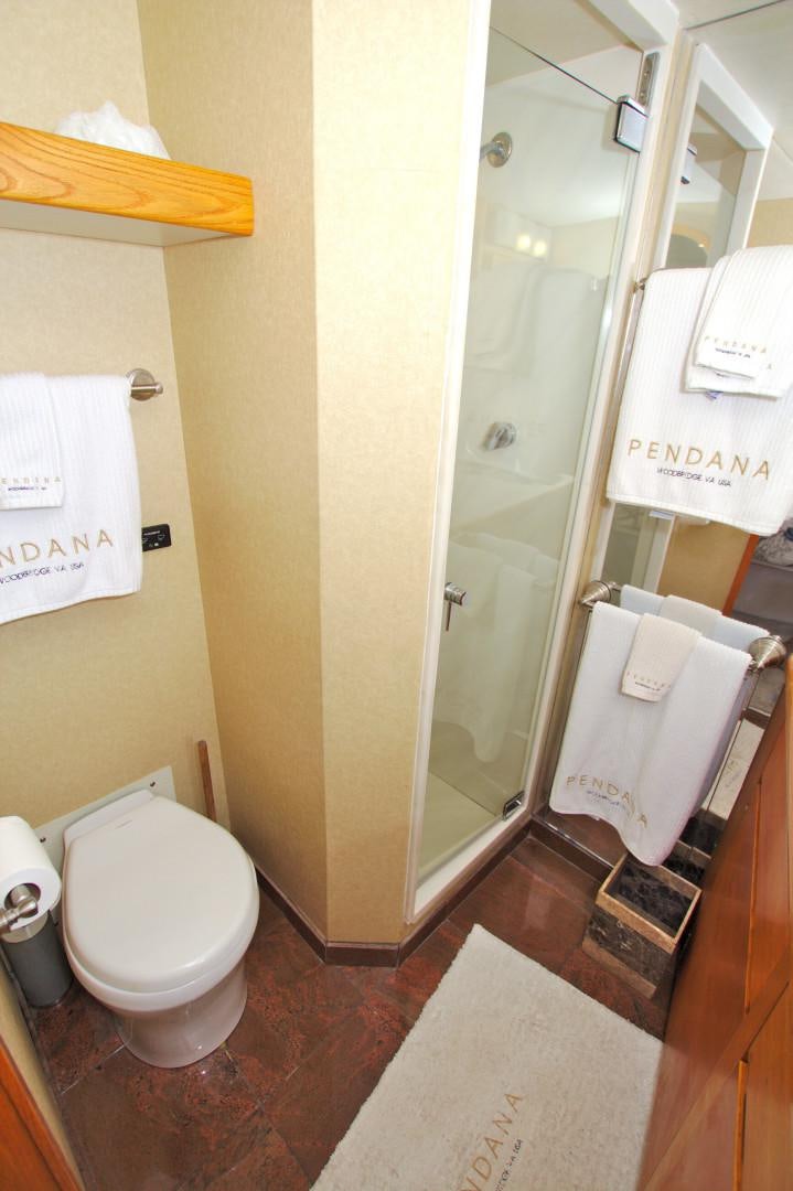 a bathroom with a toilet and a mirror aboard PENDANA Yacht for Sale