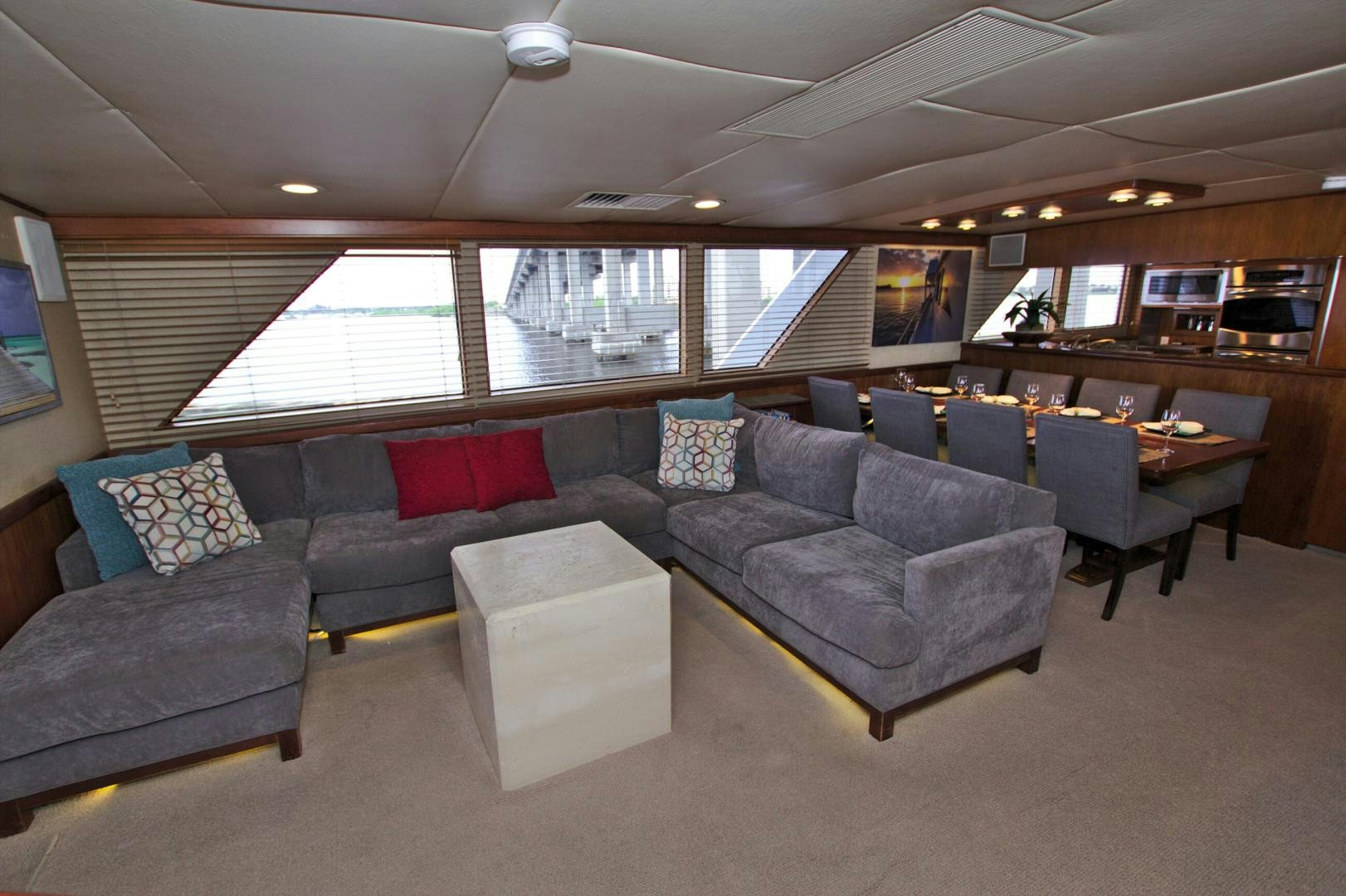 a living room with couches and a table aboard PENDANA Yacht for Sale