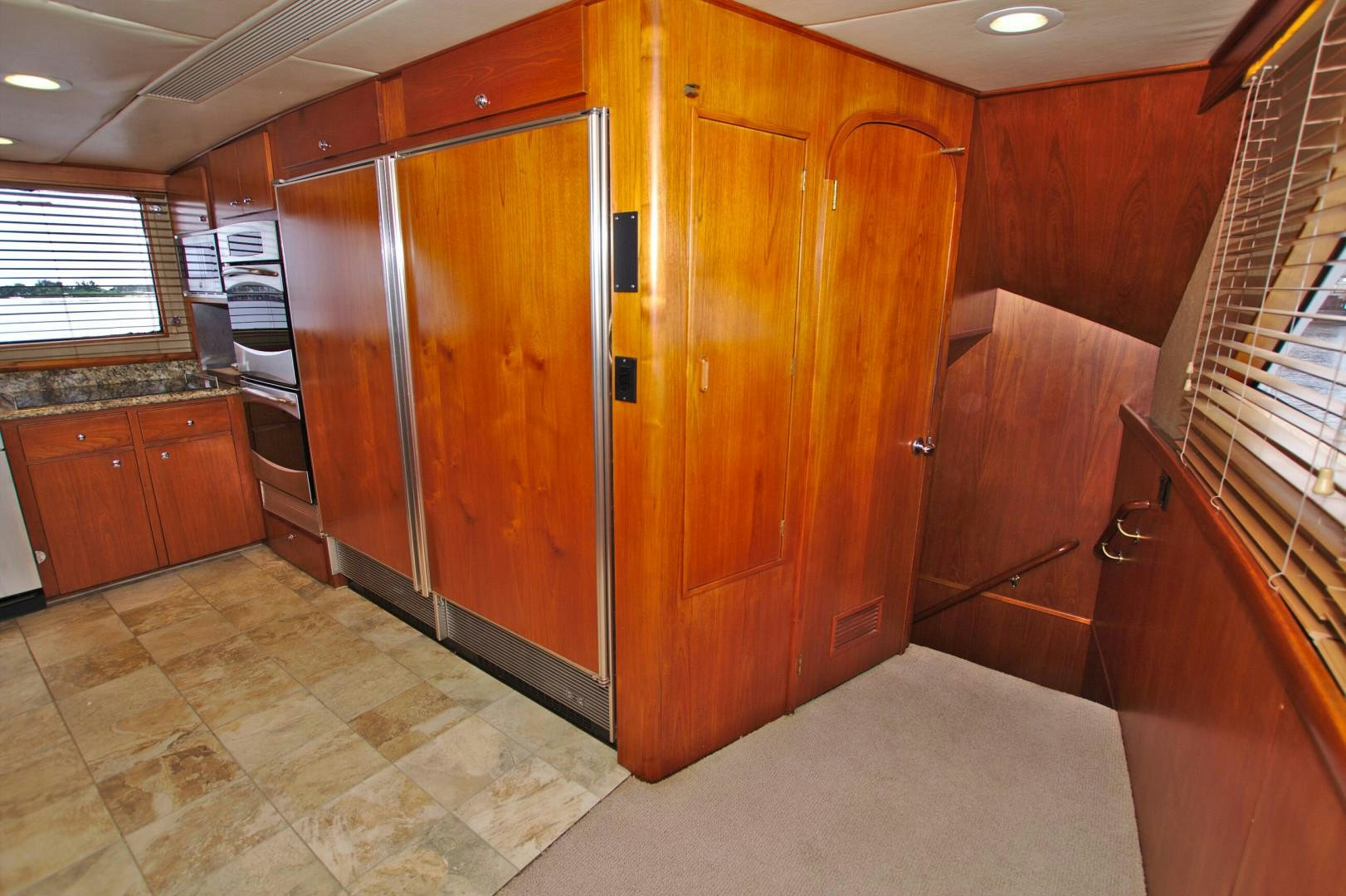 a room with wooden cabinets aboard PENDANA Yacht for Sale