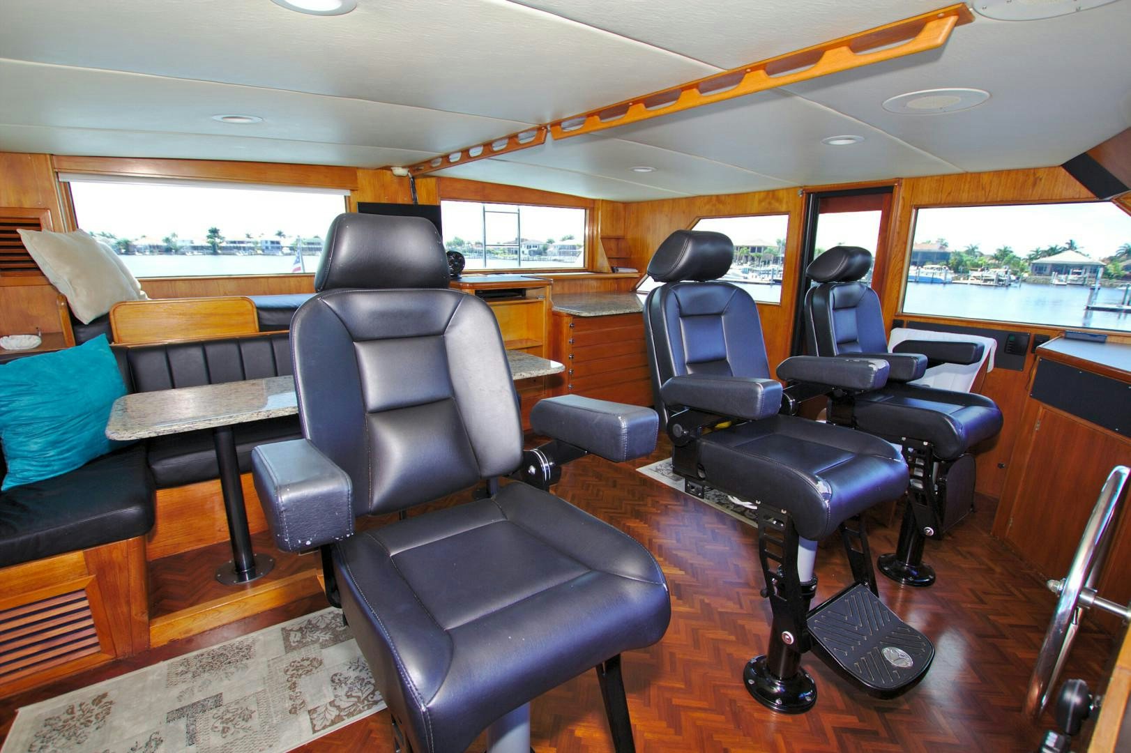 a room with chairs and a table aboard PENDANA Yacht for Sale