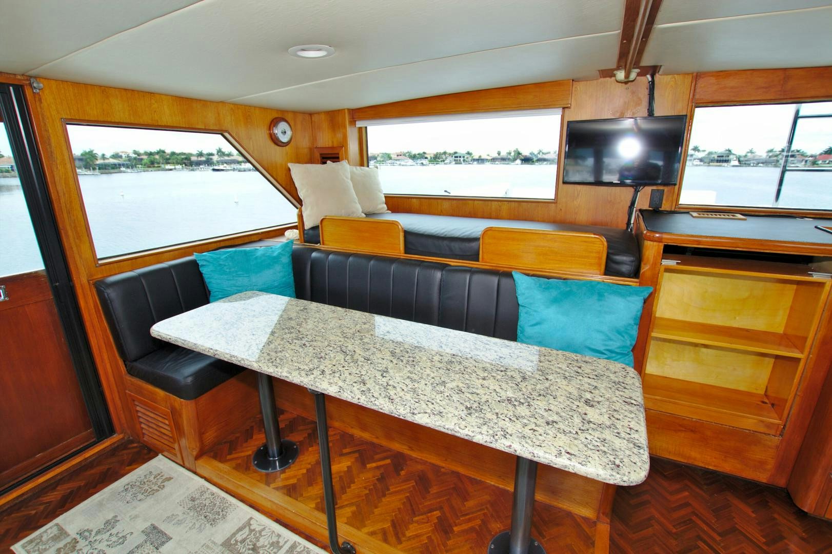 a room with a table and chairs aboard PENDANA Yacht for Sale