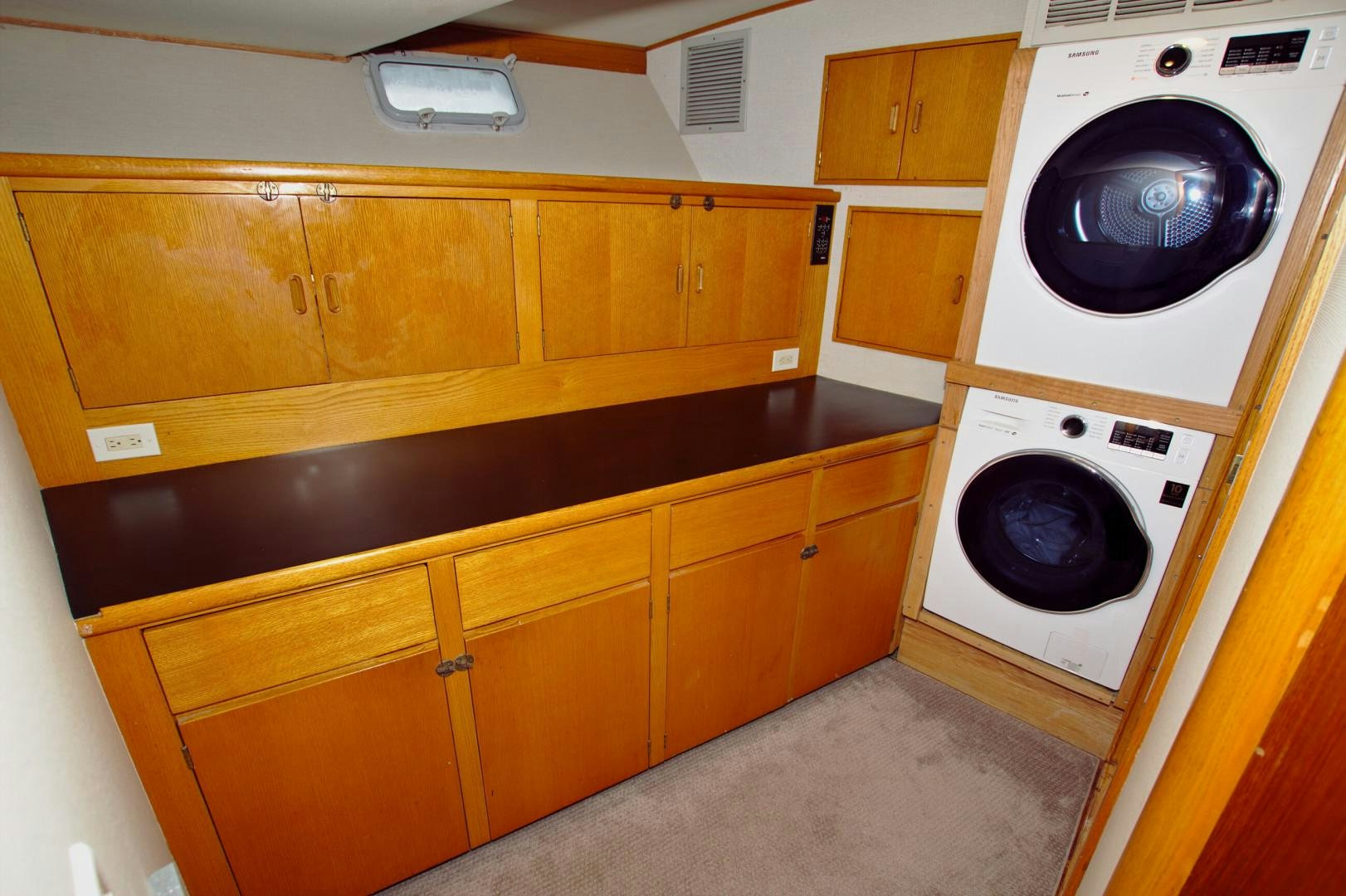 a kitchen with wooden cabinets aboard PENDANA Yacht for Sale