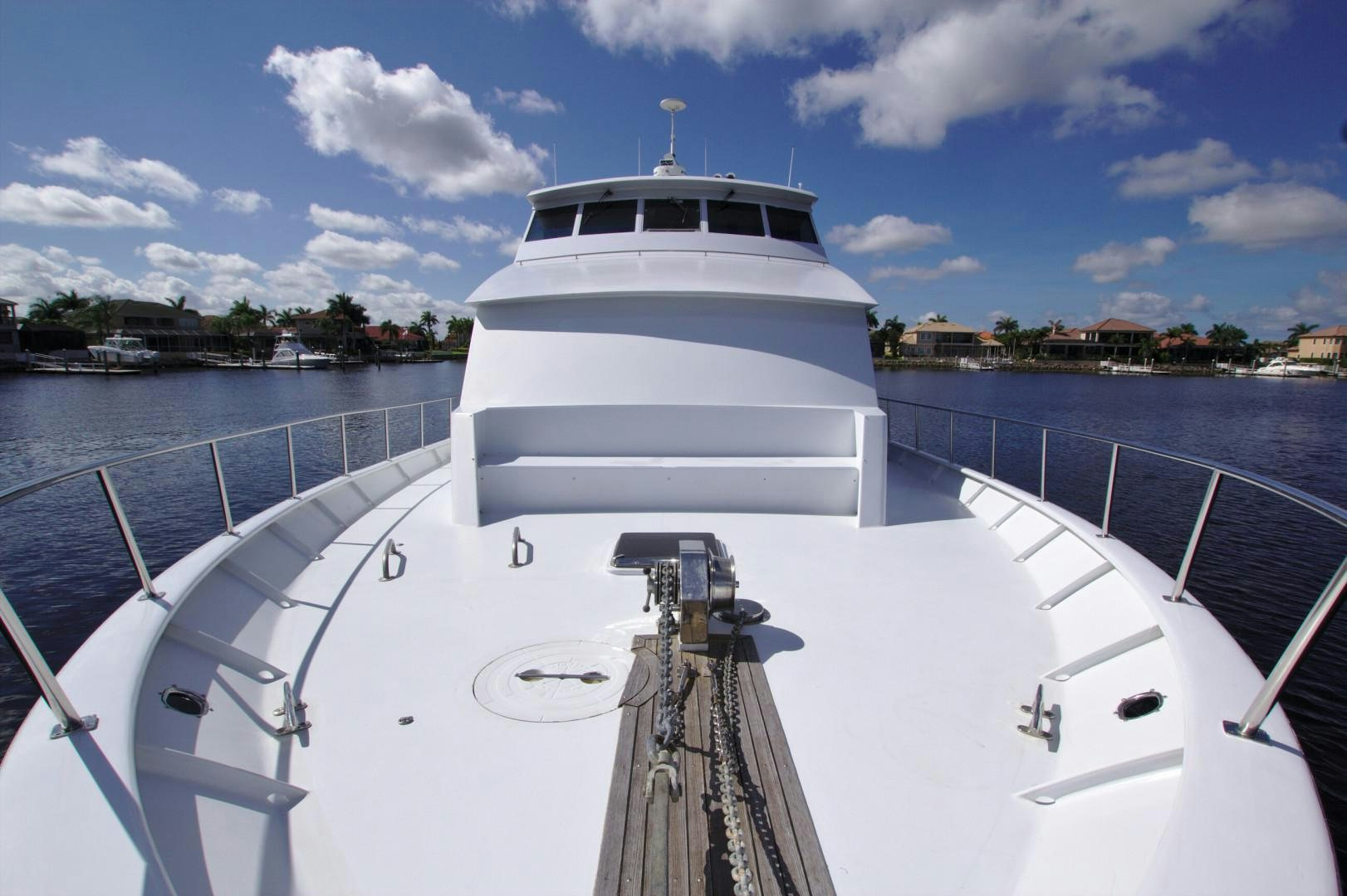 a white yacht on a dock aboard PENDANA Yacht for Sale