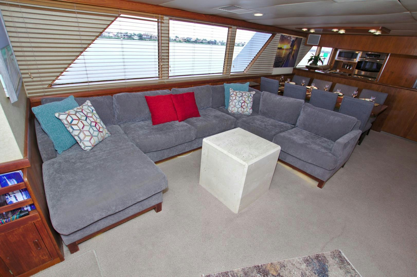 a living room with a couch and a coffee table aboard PENDANA Yacht for Sale
