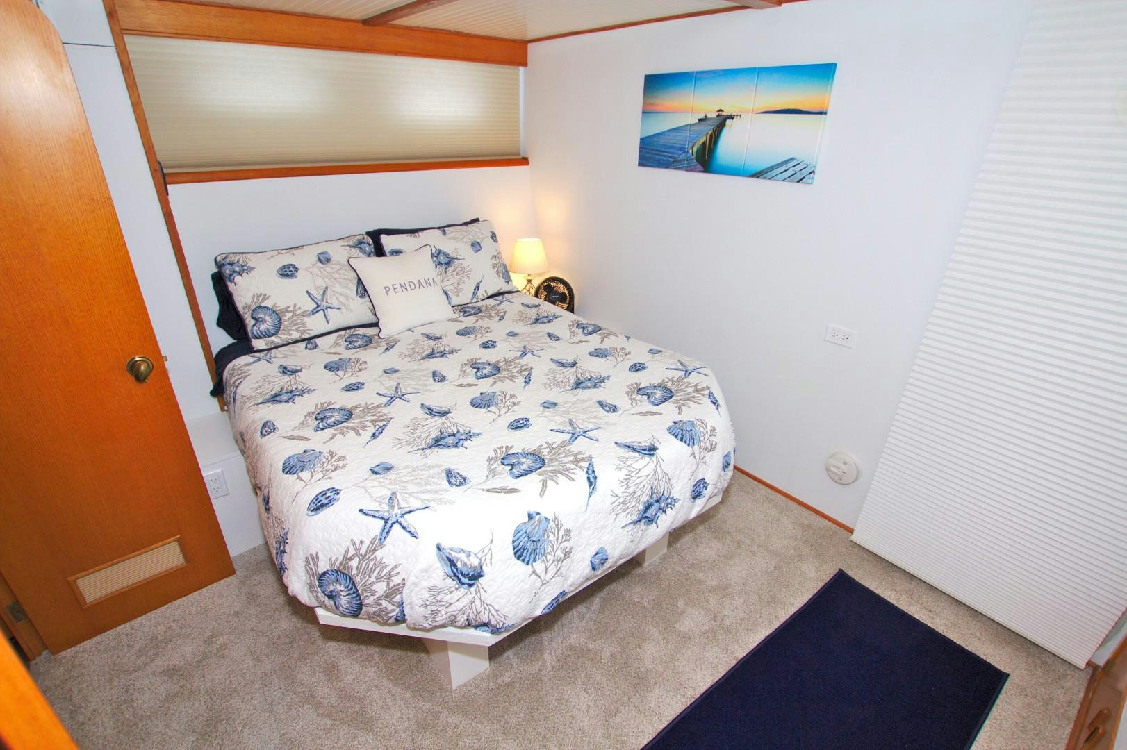 a bed with blue and white sheets aboard PENDANA Yacht for Sale