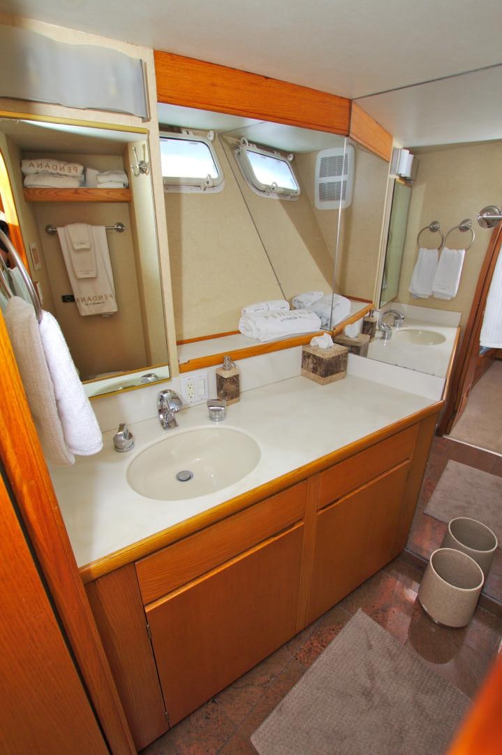 a bathroom with a sink and a mirror aboard PENDANA Yacht for Sale