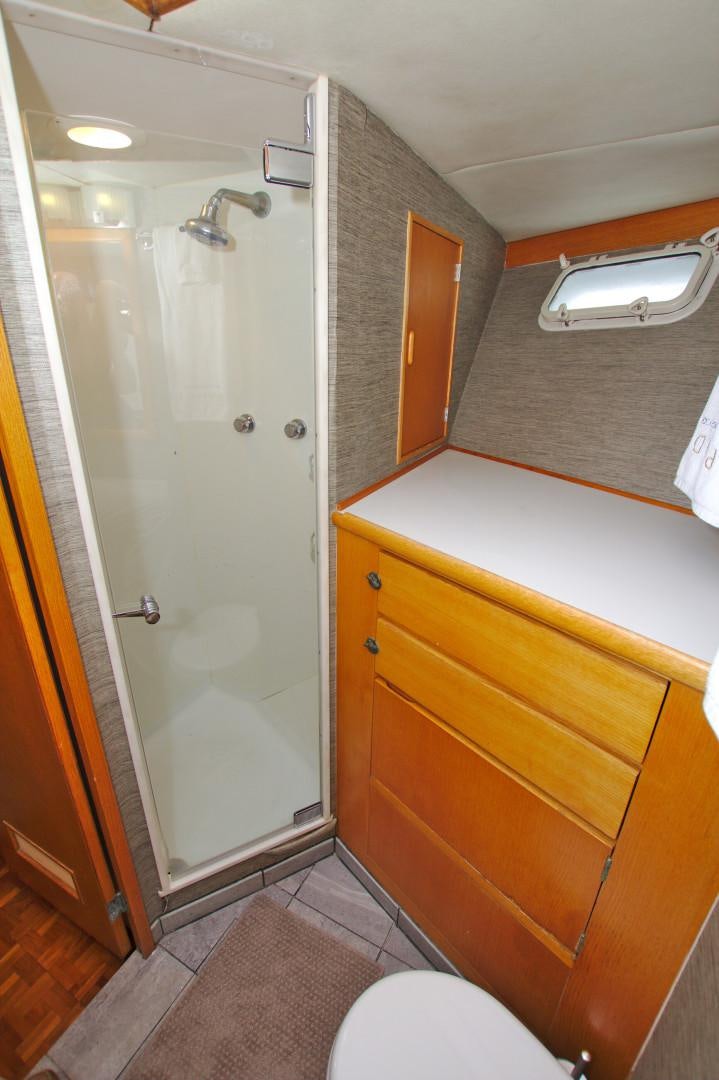 a bathroom with a shower and a toilet aboard PENDANA Yacht for Sale