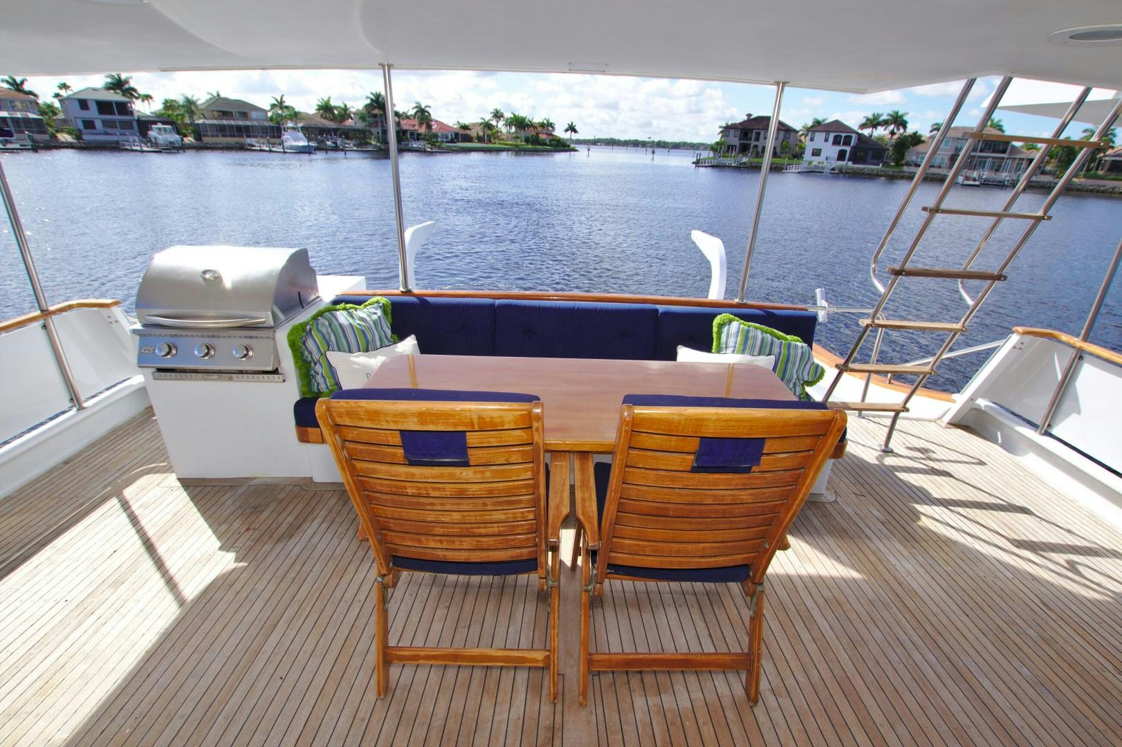 a table and chairs on a deck aboard PENDANA Yacht for Sale