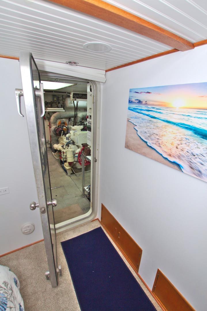 a room with a mirror and a painting on the wall aboard PENDANA Yacht for Sale