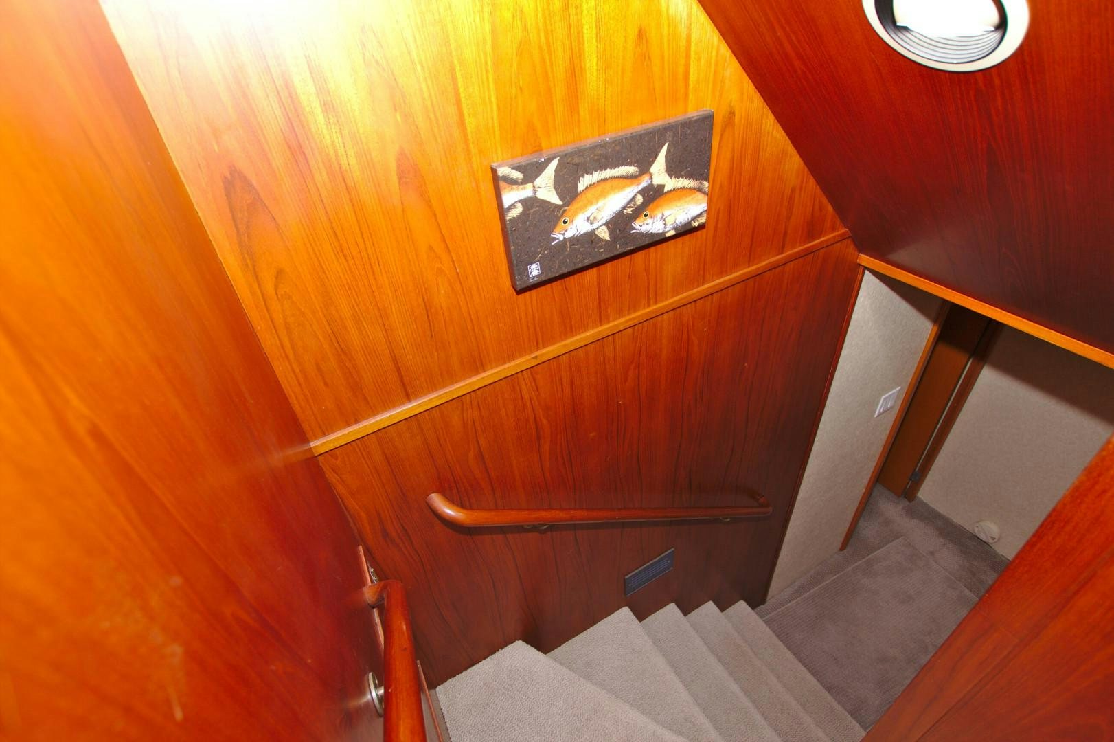 a wood cabinet with a picture of a fish on it aboard PENDANA Yacht for Sale