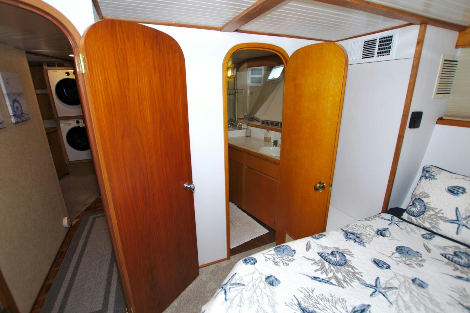 a room with a bed and a door aboard PENDANA Yacht for Sale