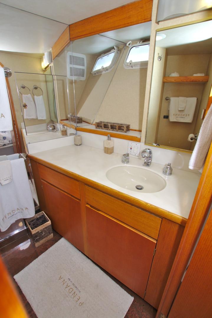 a bathroom with a sink and mirror aboard PENDANA Yacht for Sale