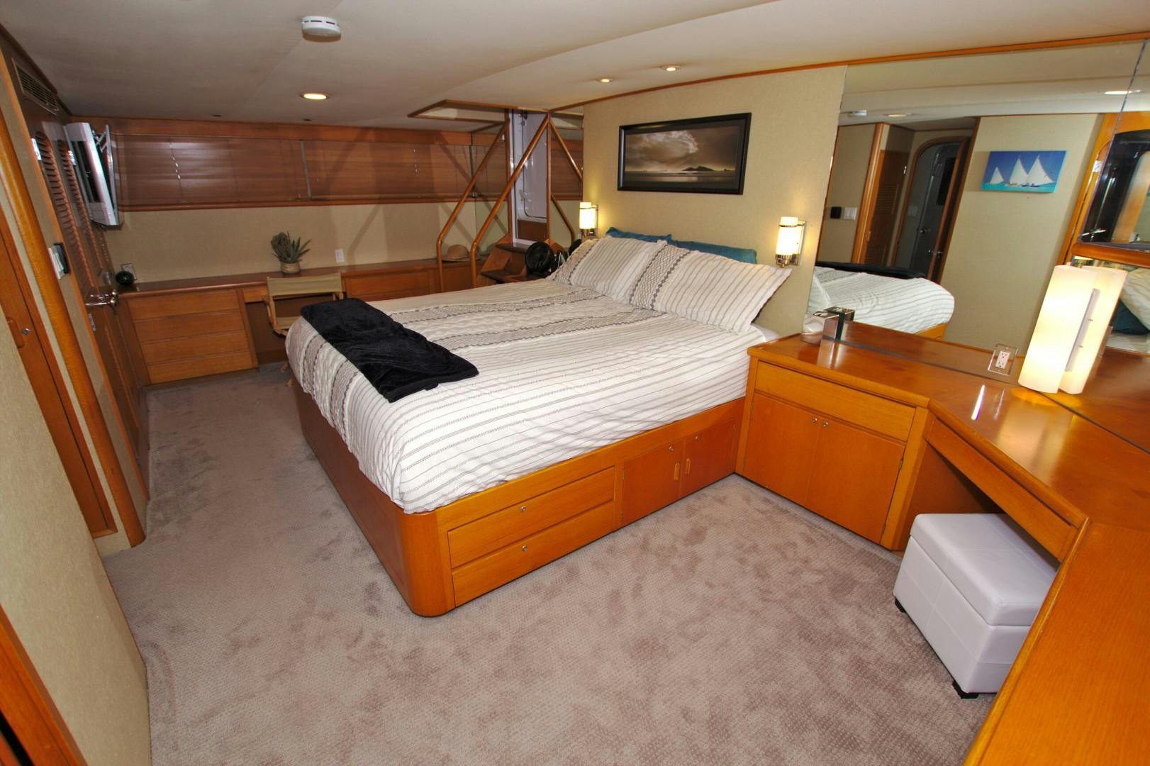 a room with a bed and a television aboard PENDANA Yacht for Sale