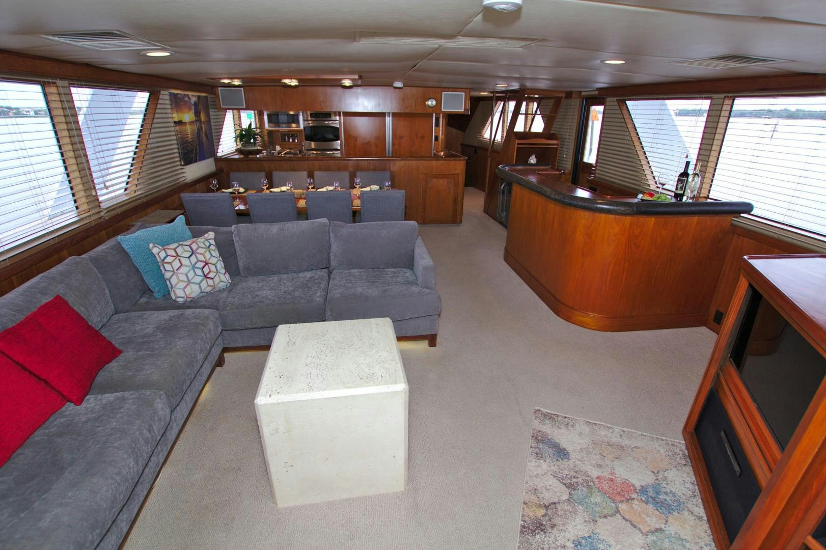a large living room with a large couch and a large table aboard PENDANA Yacht for Sale