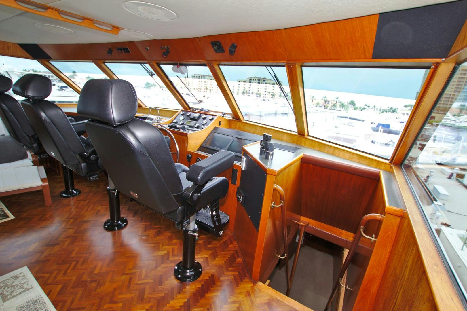 a room with a bench and chairs aboard PENDANA Yacht for Sale