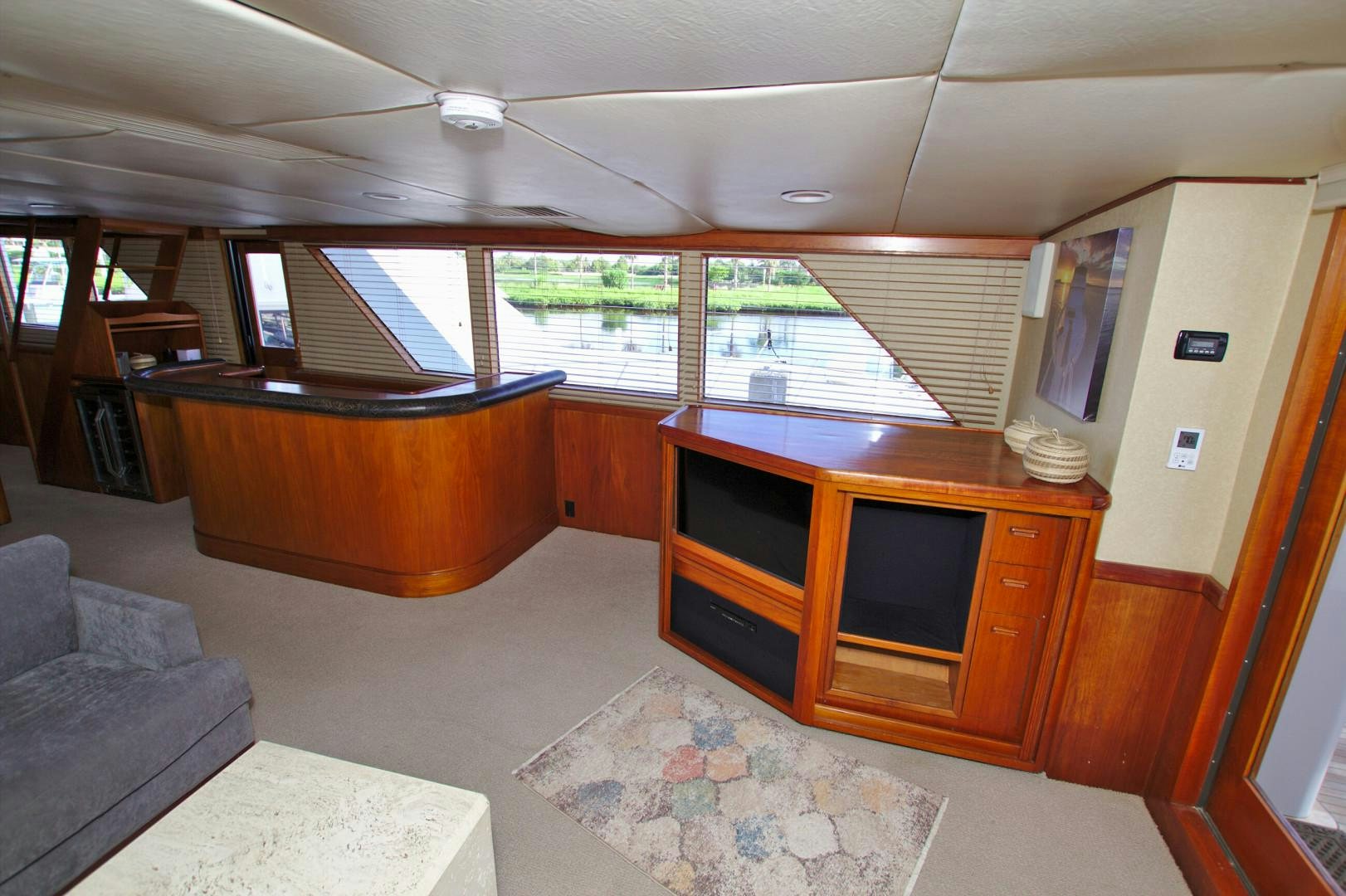 a living room with a couch and a tv aboard PENDANA Yacht for Sale