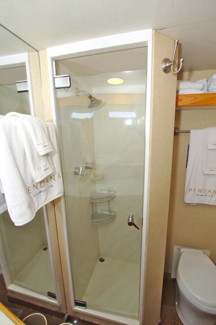 a bathroom with a glass shower door aboard PENDANA Yacht for Sale