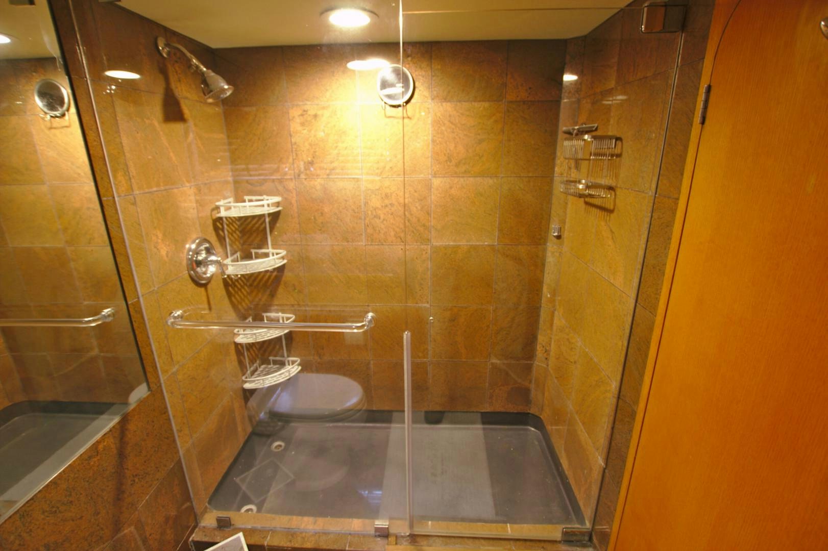 a bathroom with a glass shower aboard PENDANA Yacht for Sale