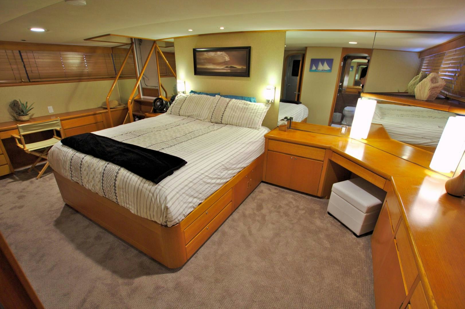 a hotel room with a bed and desk aboard PENDANA Yacht for Sale