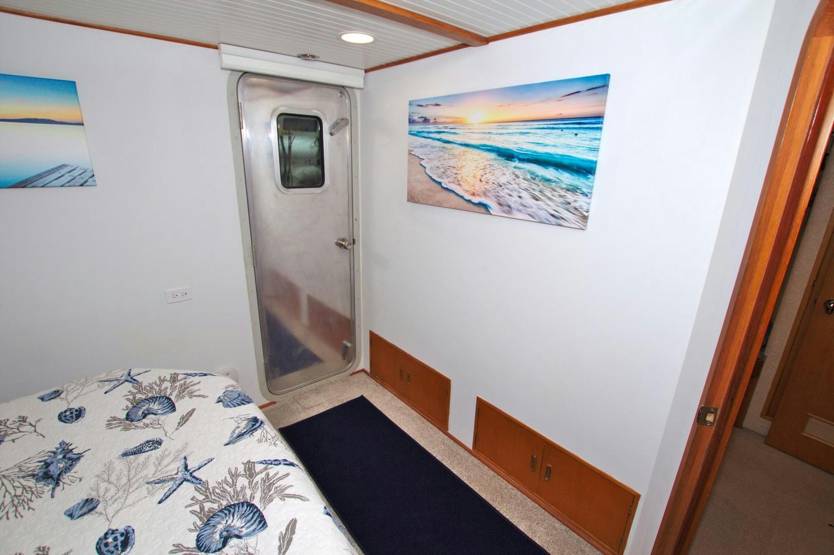 a room with a bed and a door aboard PENDANA Yacht for Sale