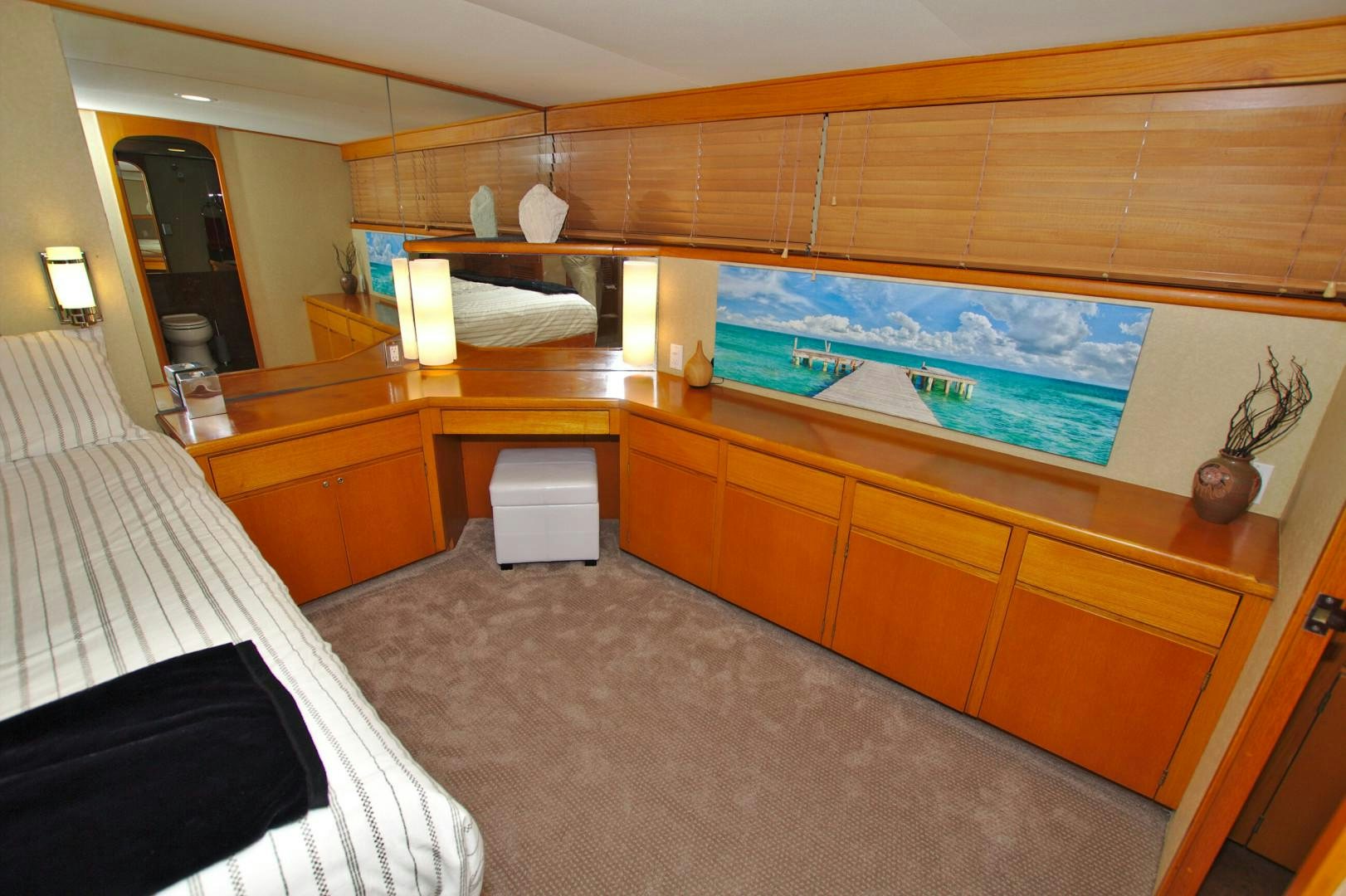 a room with a bed and a television aboard PENDANA Yacht for Sale