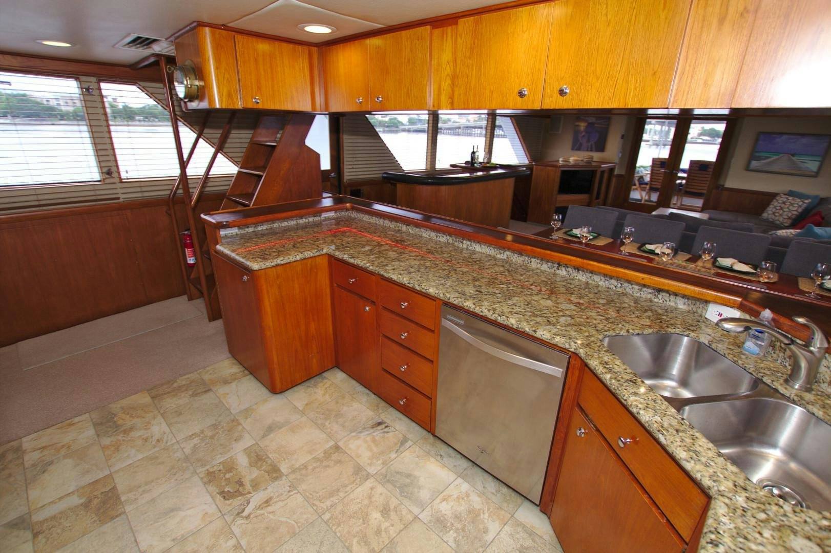 a kitchen with wooden cabinets aboard PENDANA Yacht for Sale