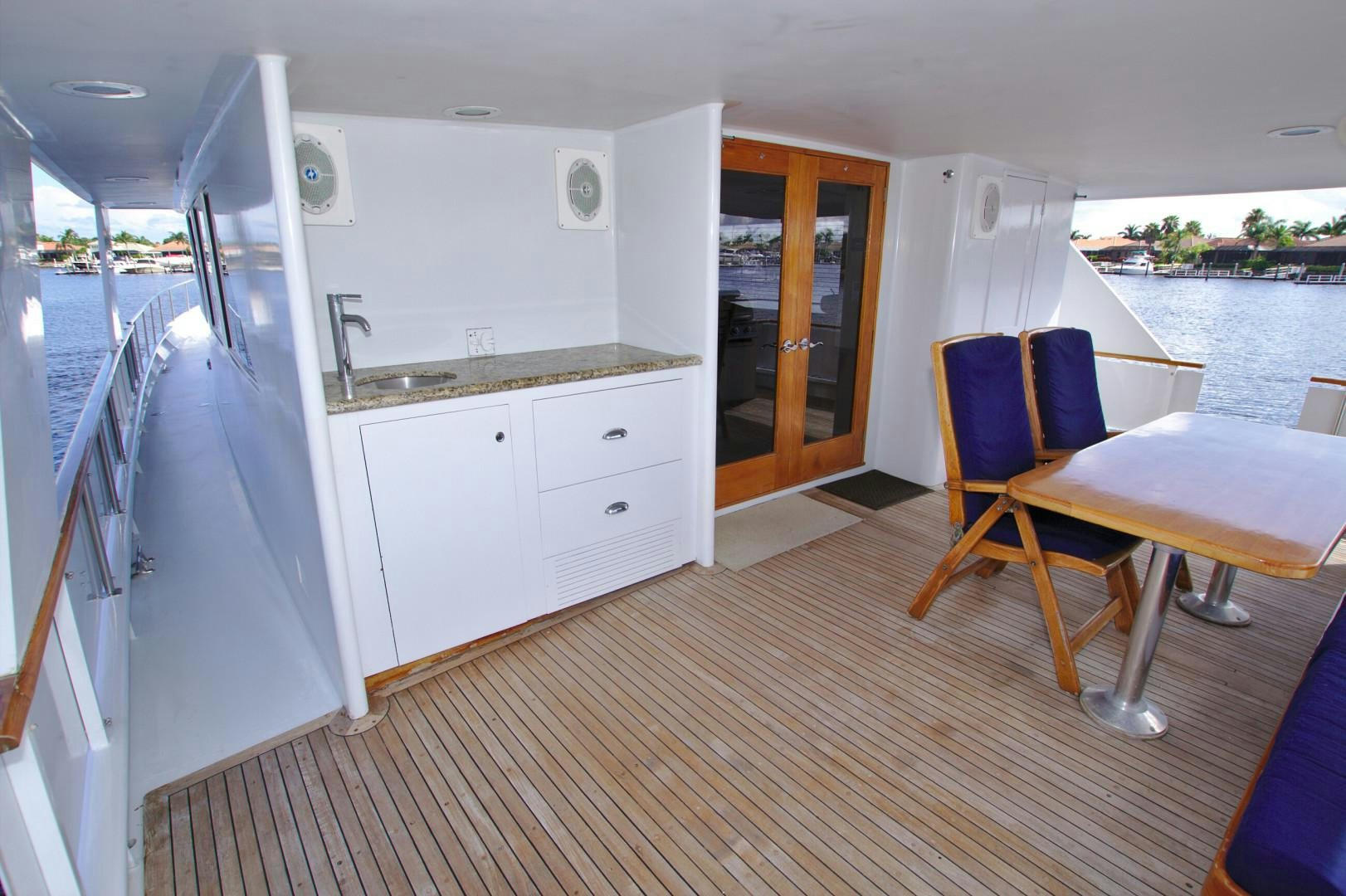 a room with a table and chairs aboard PENDANA Yacht for Sale