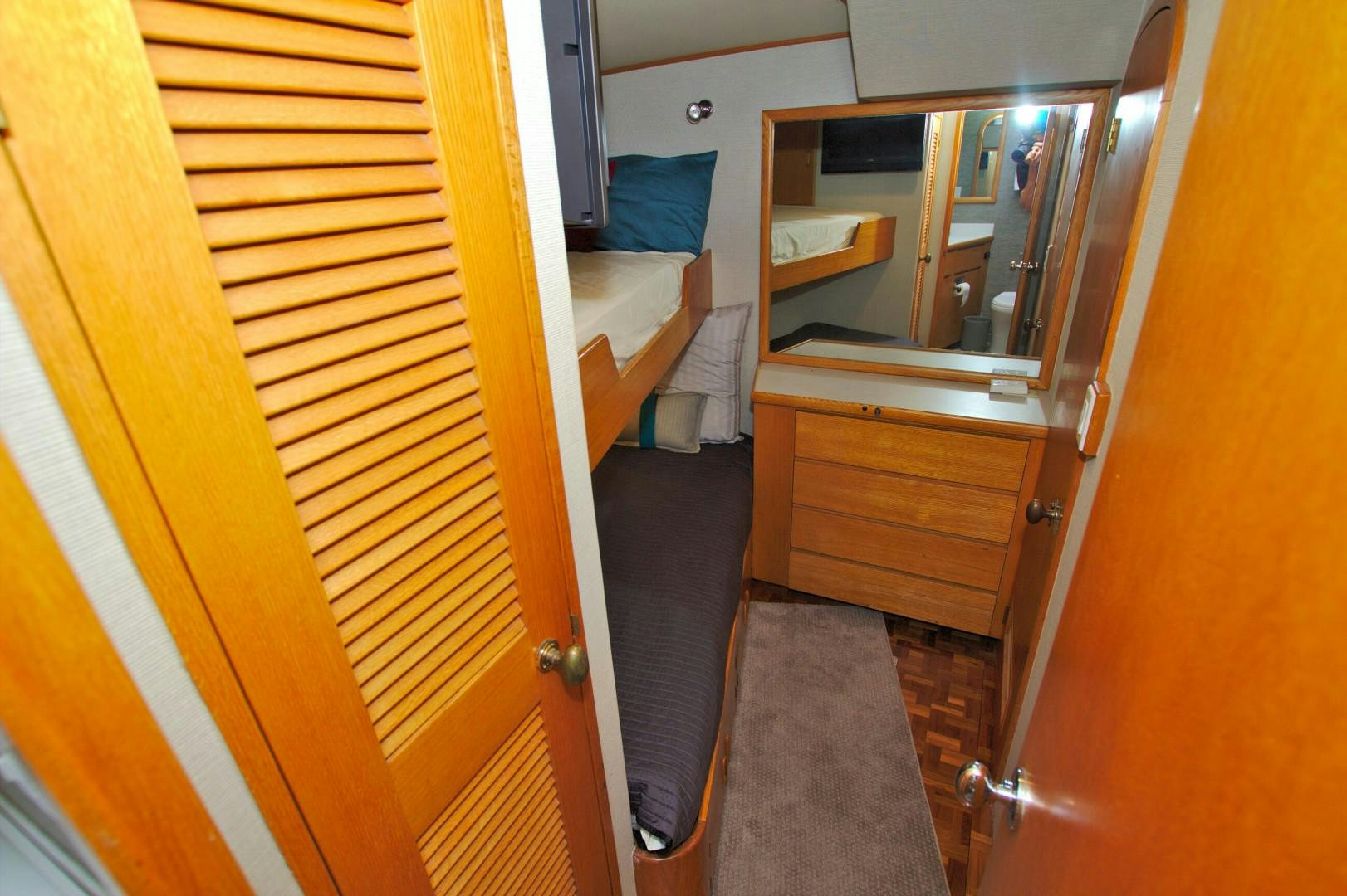 a bathroom with a bed and a mirror aboard PENDANA Yacht for Sale