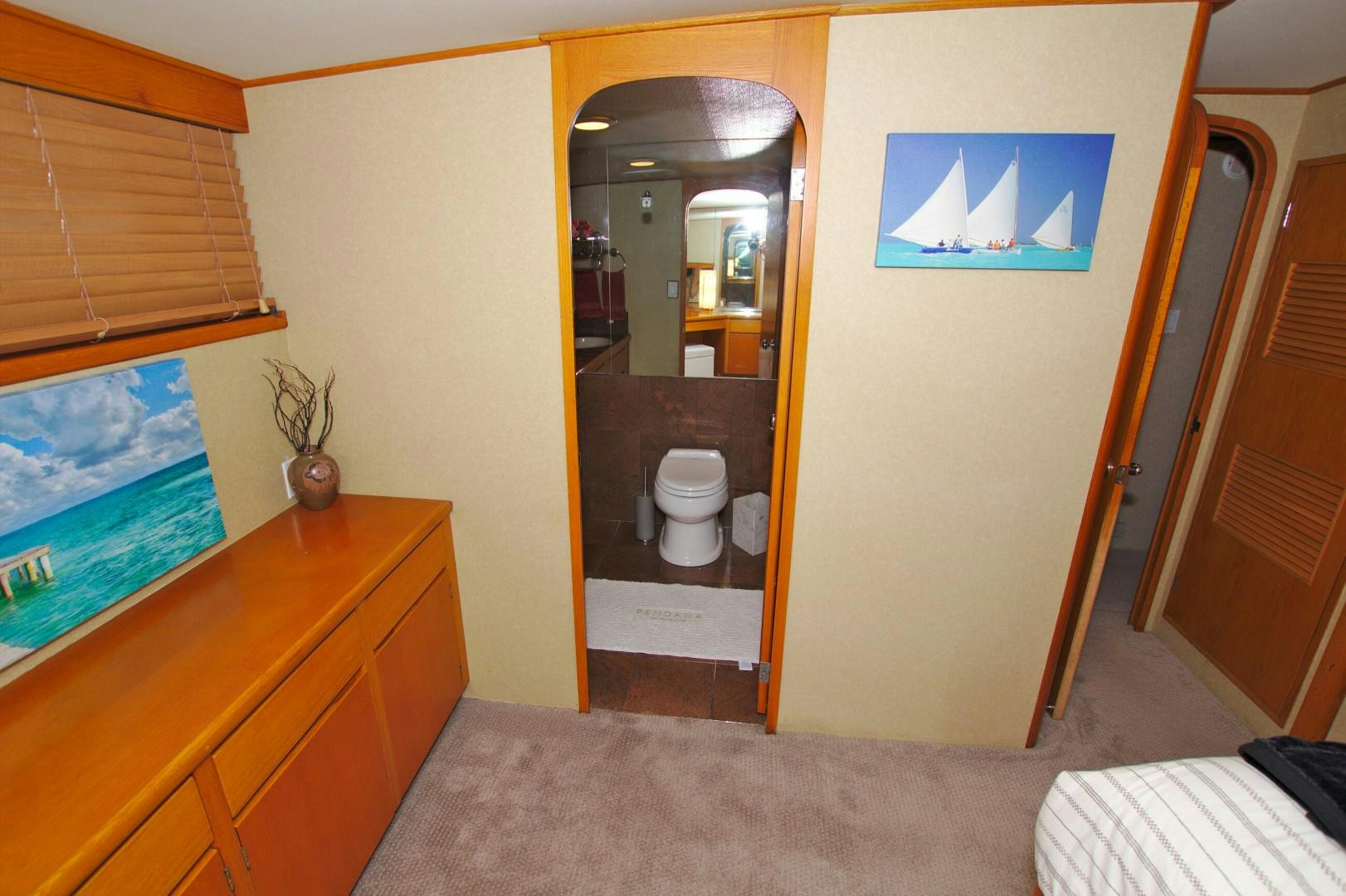 a bathroom with a toilet and a mirror aboard PENDANA Yacht for Sale