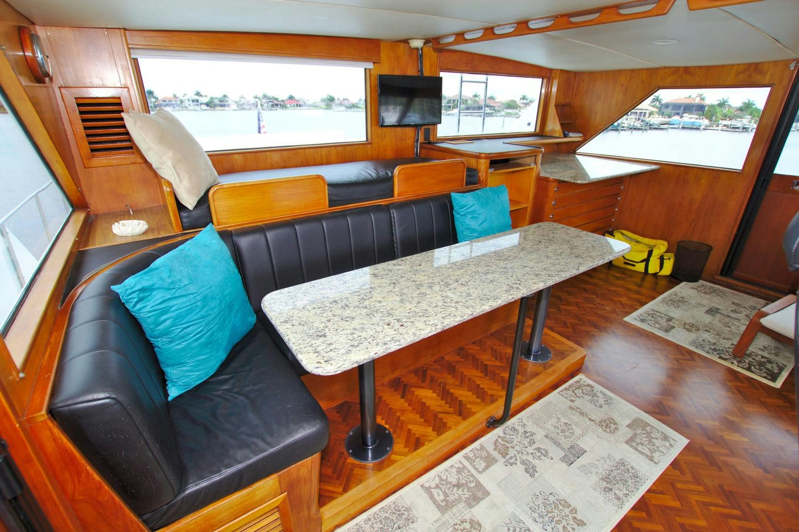 a living room with a couch and a coffee table aboard PENDANA Yacht for Sale