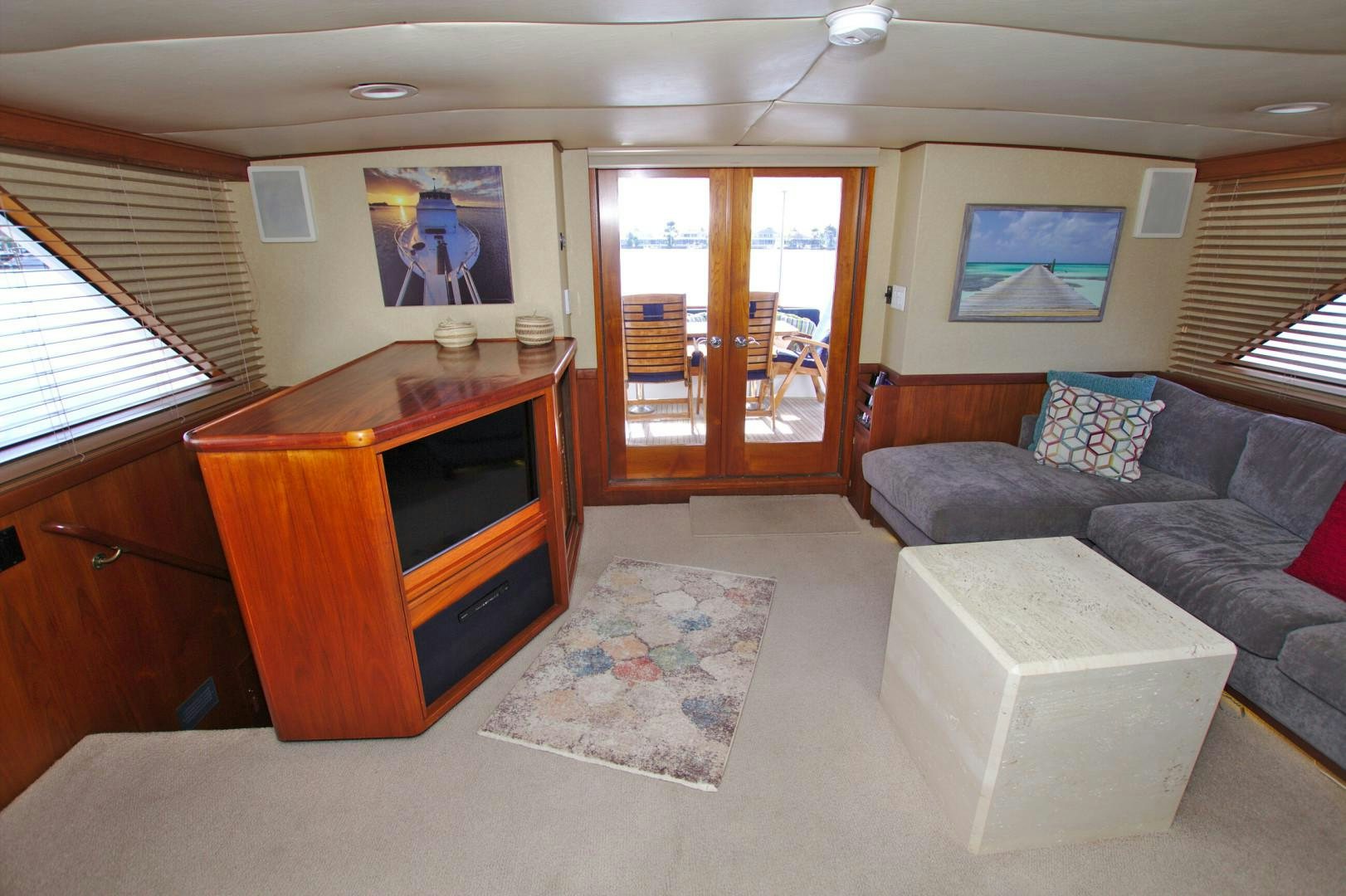 a living room with a couch and a tv aboard PENDANA Yacht for Sale