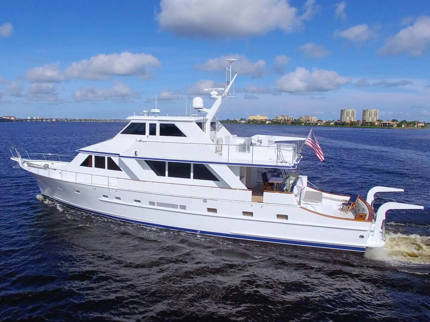 a white yacht on the beach aboard PENDANA Yacht for Sale