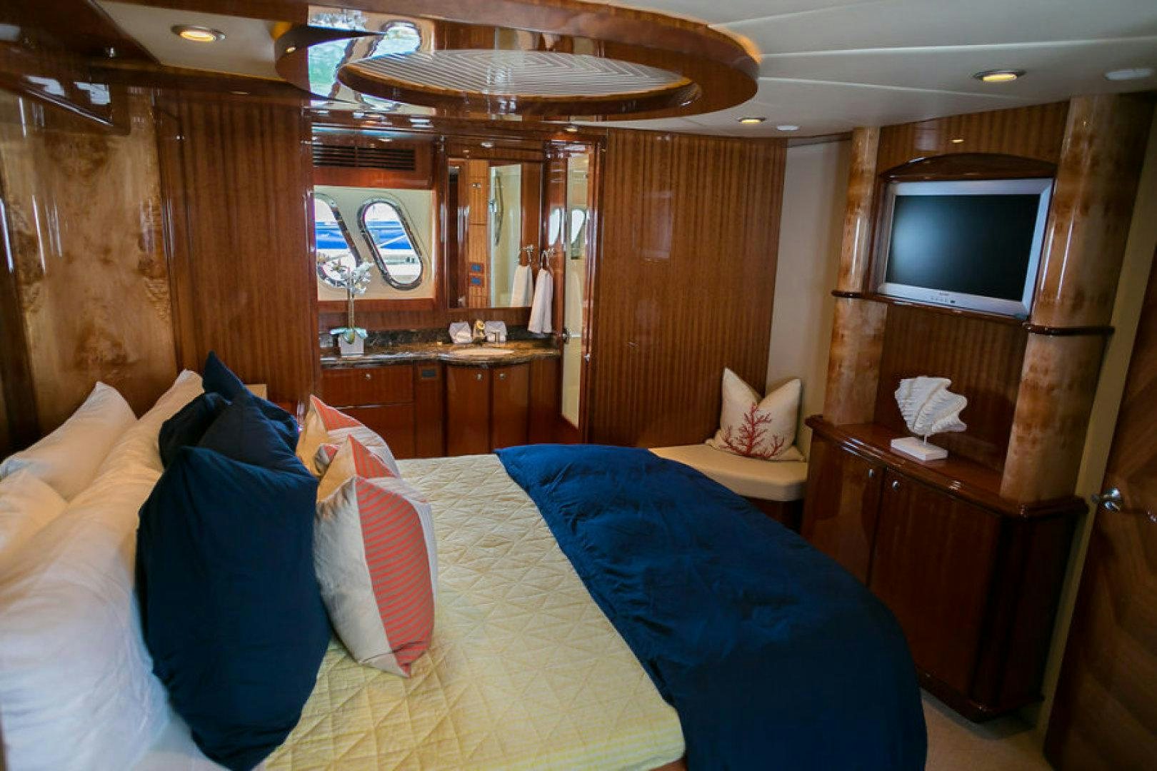 a room with a bed and a television aboard CONDORS NEST Yacht for Sale