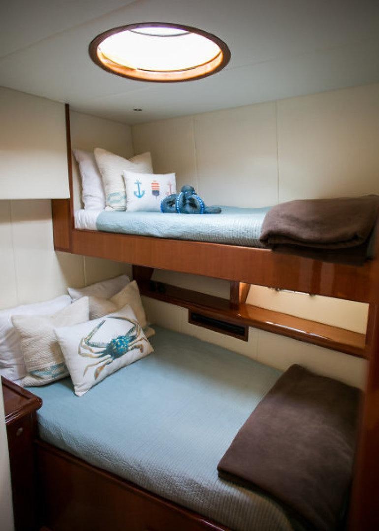 a room with a bed and a table aboard CONDORS NEST Yacht for Sale