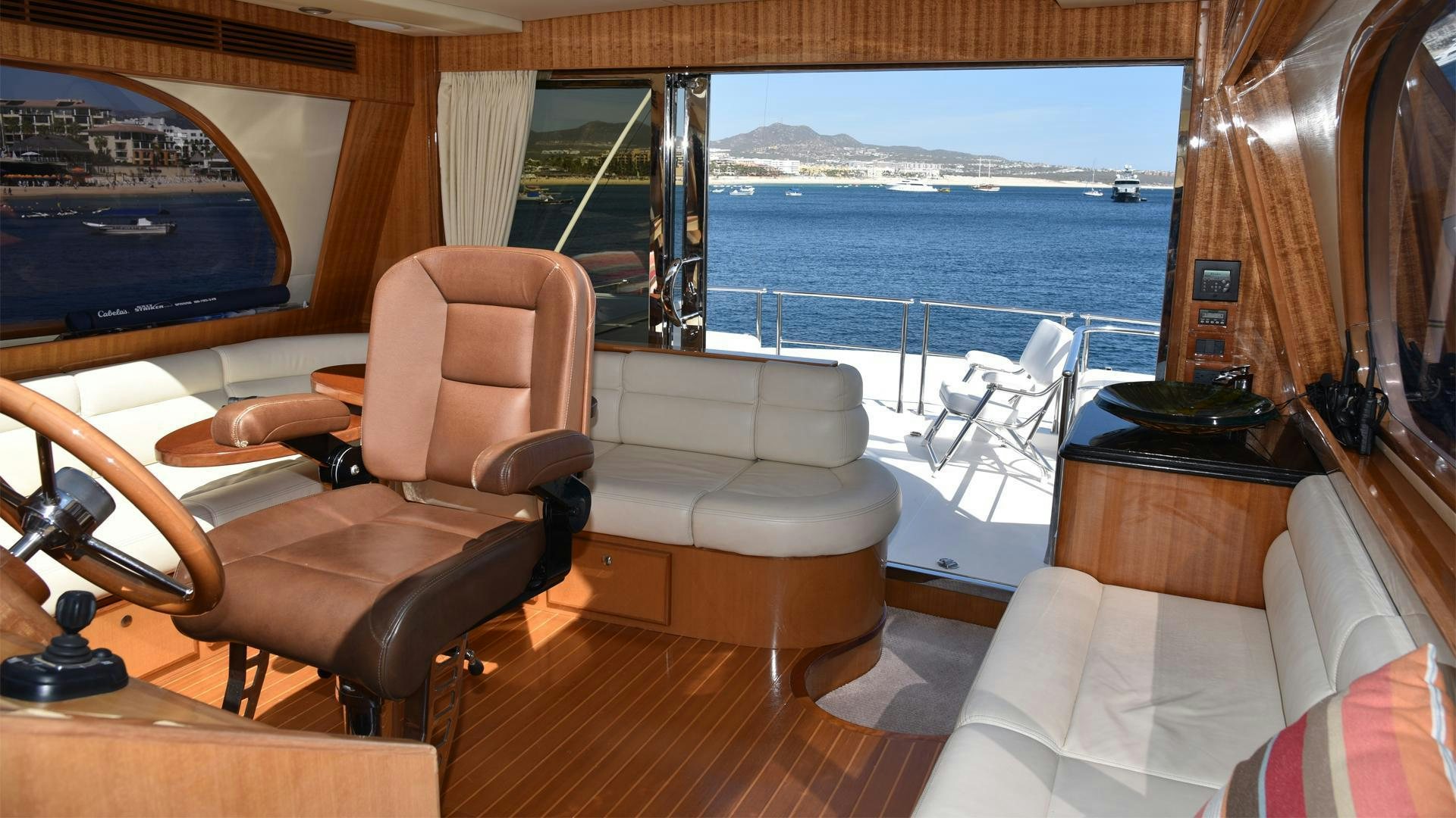 a room with a view of the ocean and a large television aboard CONDORS NEST Yacht for Sale