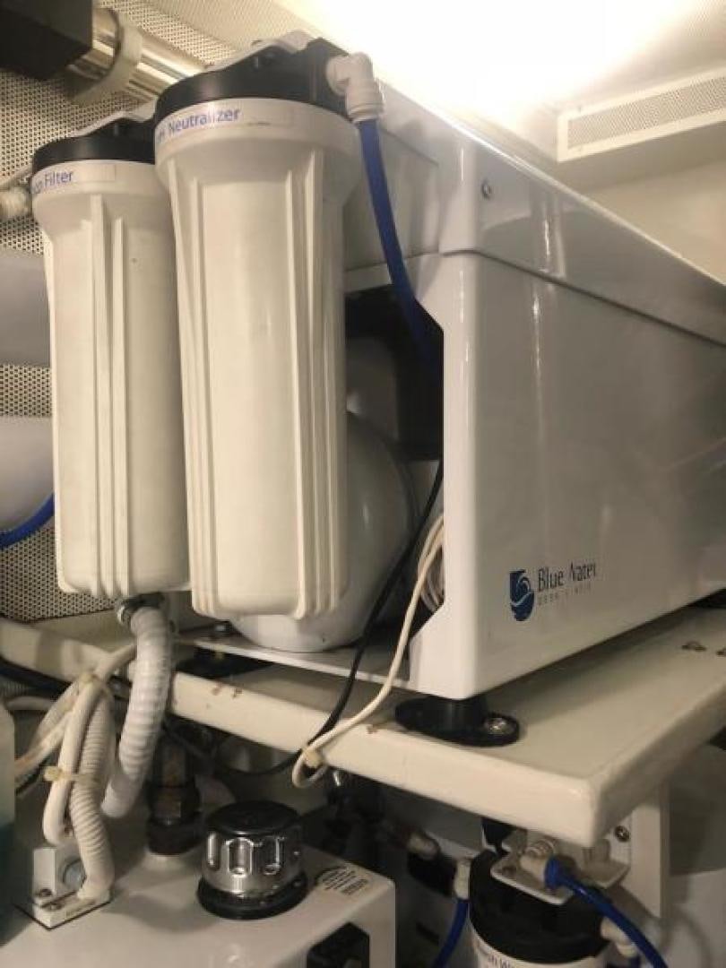 a white machine with a blue cable aboard CONDORS NEST Yacht for Sale