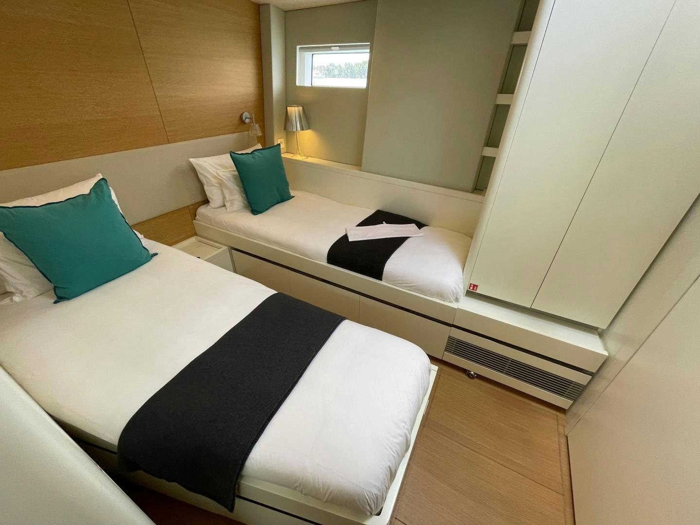 a room with a couple of beds aboard KESTREL Yacht for Sale