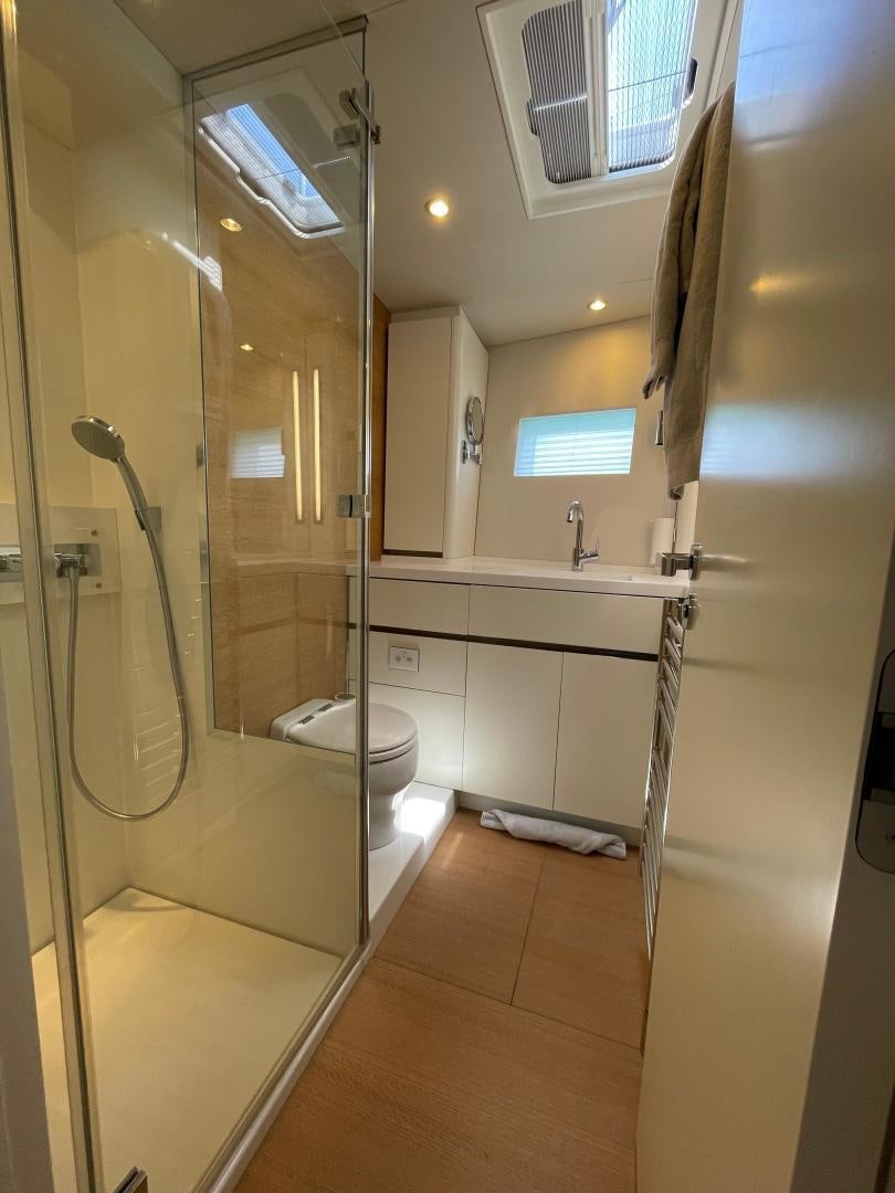 a bathroom with a glass shower aboard KESTREL Yacht for Sale