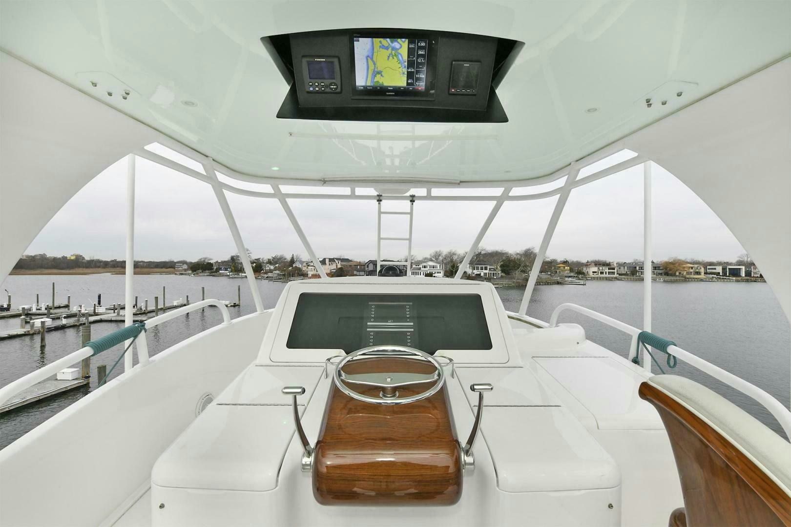 a boat with a clock on the front aboard ON THE EDGE Yacht for Sale