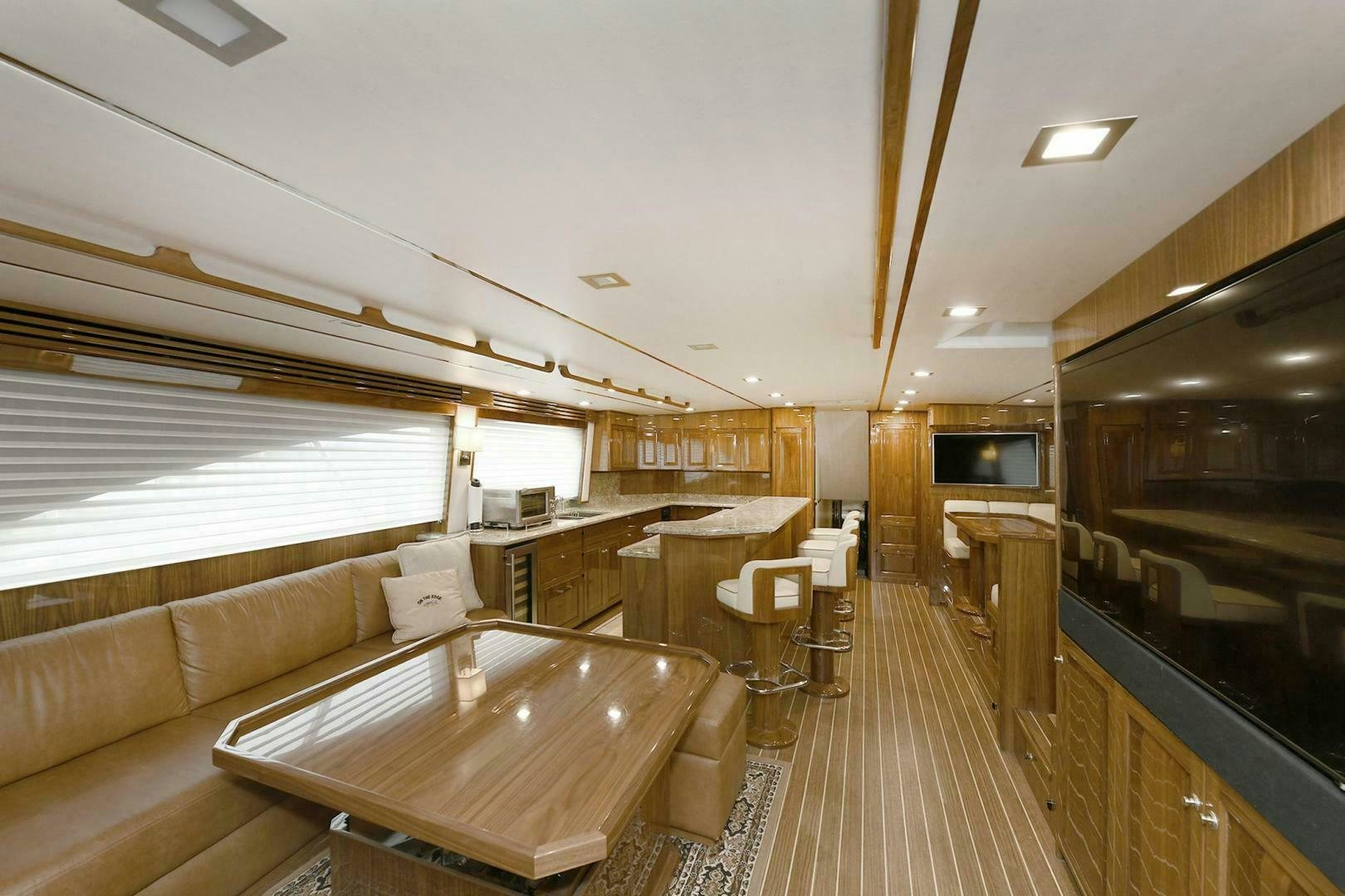 a large room with a couch and a television aboard ON THE EDGE Yacht for Sale