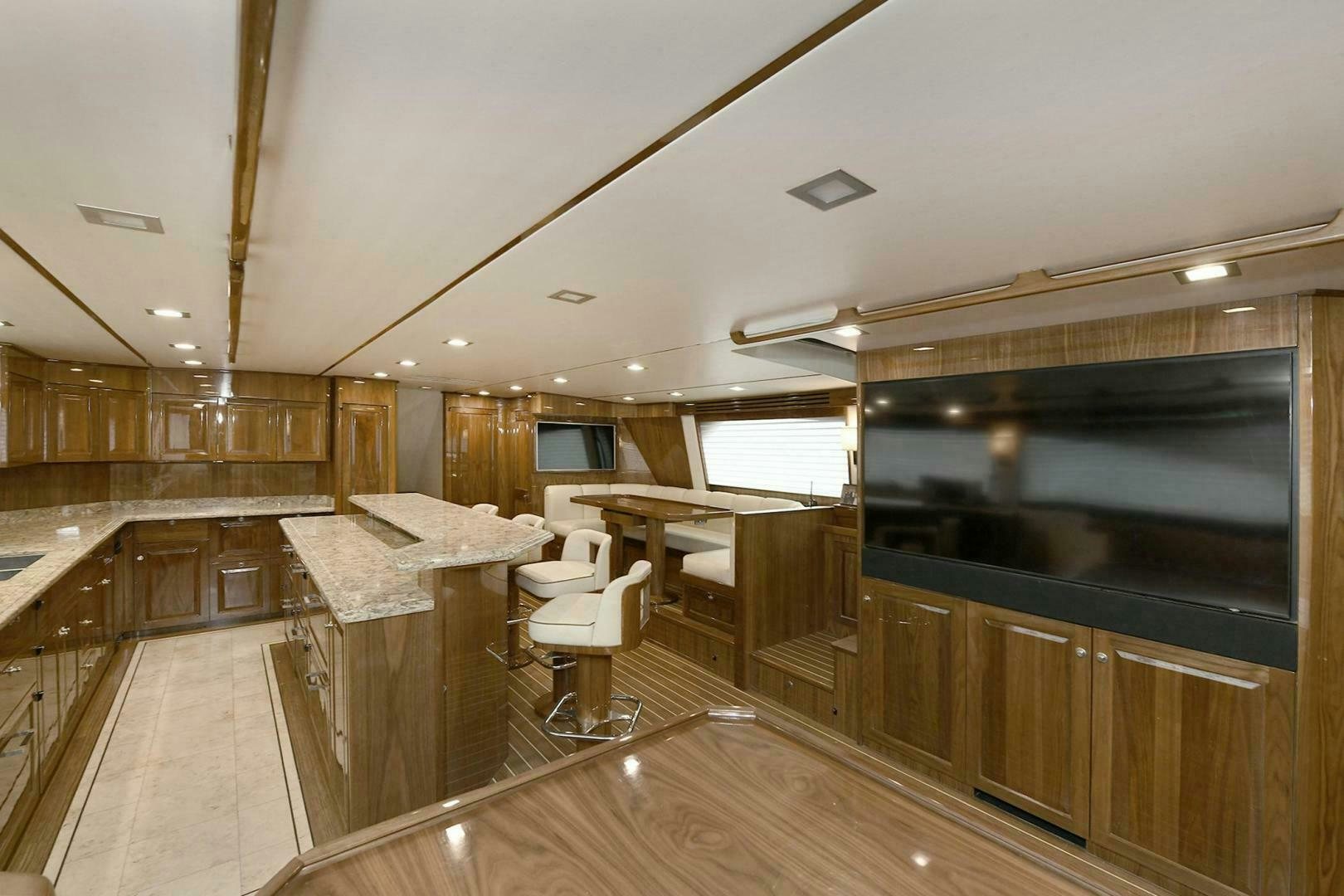 a large kitchen with wooden cabinets aboard ON THE EDGE Yacht for Sale