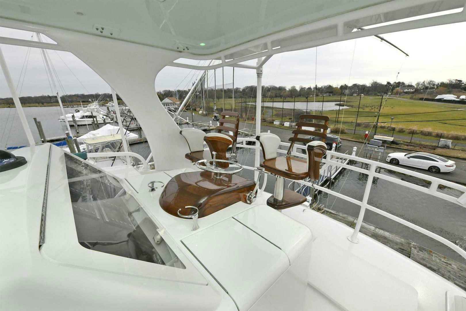 a boat with a wooden steering wheel aboard ON THE EDGE Yacht for Sale