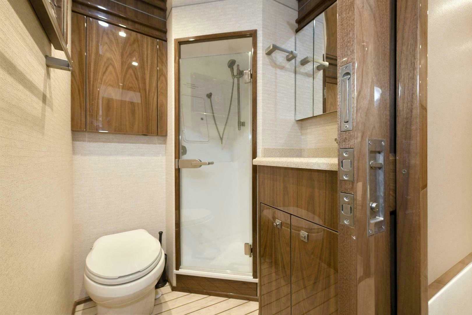 a bathroom with a toilet and a shower aboard ON THE EDGE Yacht for Sale