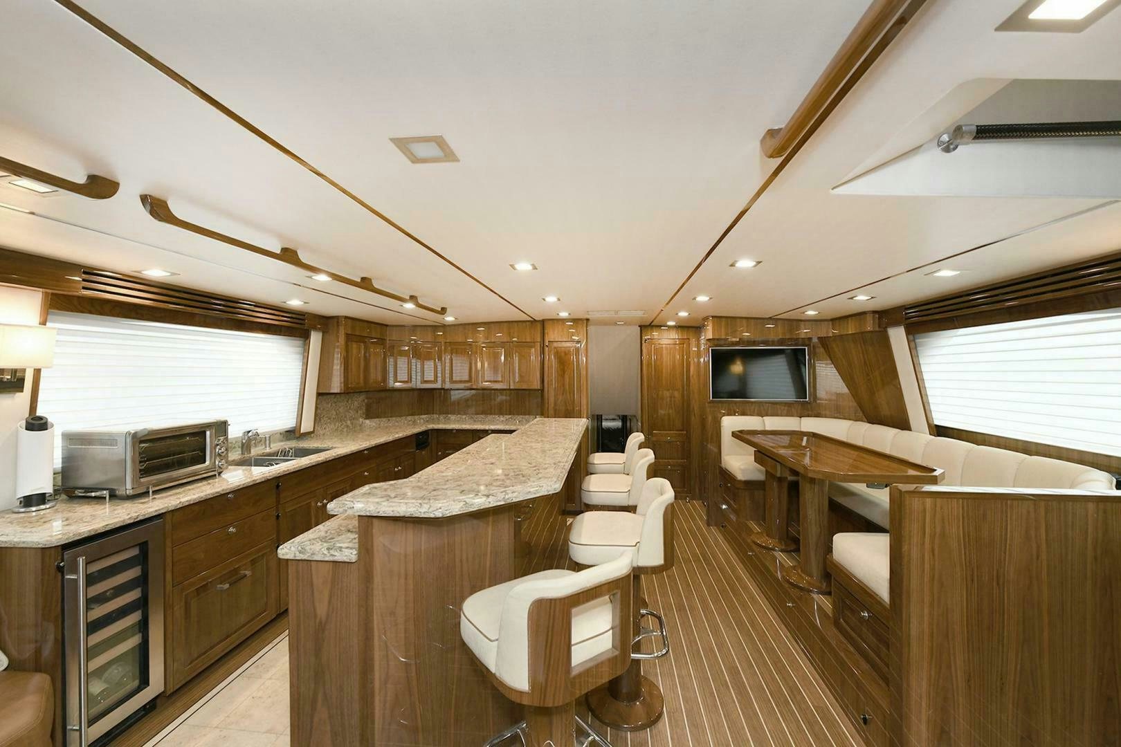 a kitchen with a bar and a dining area aboard ON THE EDGE Yacht for Sale